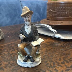 Man feather pen and book porcelain figurine